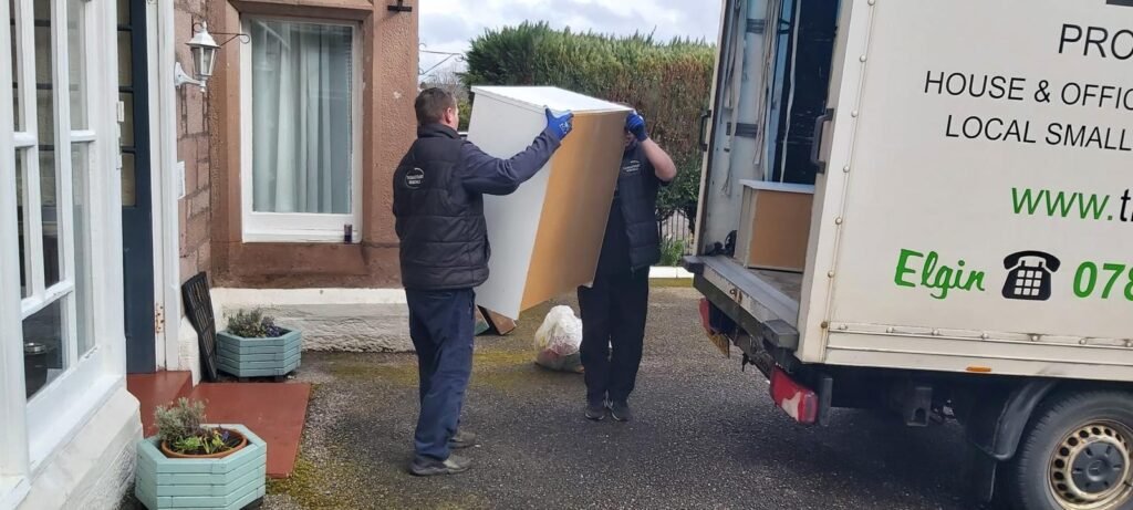 Movers loading furniture into a removal truck